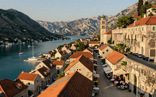 Kotor old town with medieval walls climbing mountains alongside turquoise bay